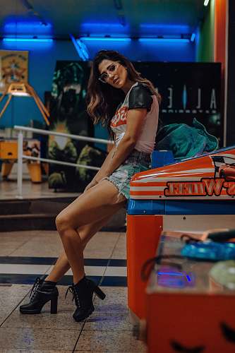 people woman sitting on arcade machine human