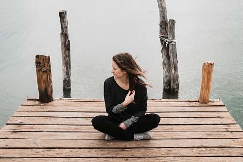 human woman sitting on dock during daytime people