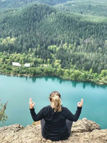 people woman sitting on mountain edge human