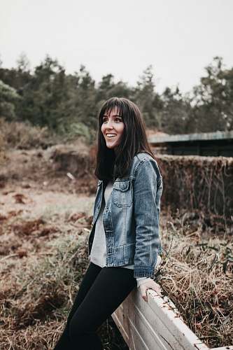 human woman sitting on rail during daytime people