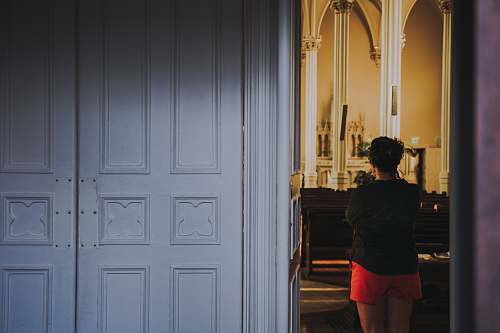 human woman standing beside white door people