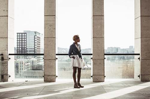 people woman standing in building next to window human