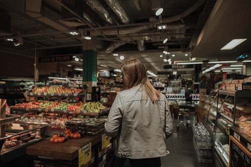 human woman standing in front of assorted vegetables people