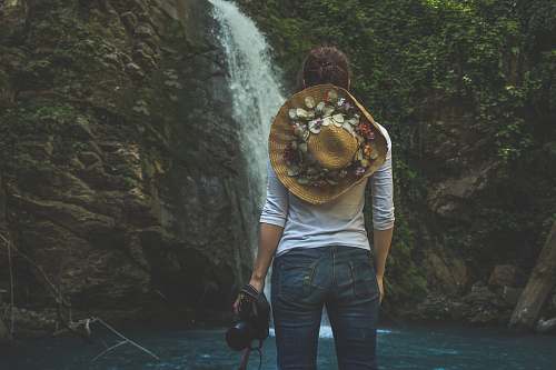 people woman standing in front of waterfalls human