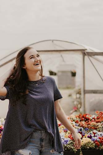 people woman standing near assorted flowers outdoors human