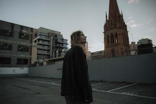 people woman standing near cathedral looking at sky building
