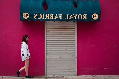 people woman standing near Royal Fabrics signage human