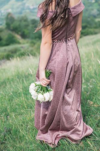 people woman standing on grass fields holding bouquet of white flowers human