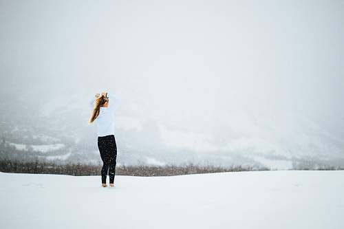 snow woman standing on open field covered in snow at daytime female