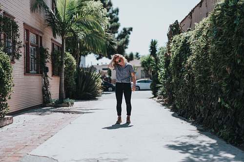 human woman standing on street near house people