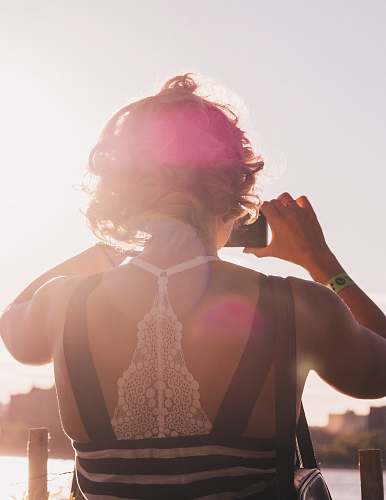 people woman taking photo of bay during daytime human