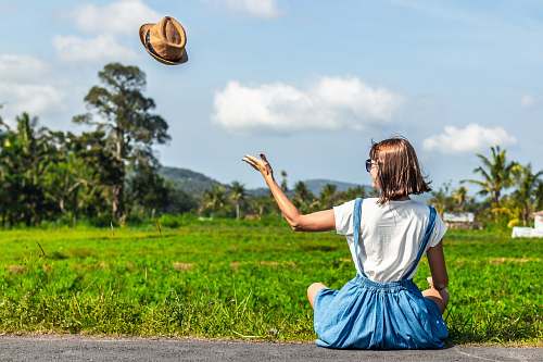 human woman throwing up brown hat people
