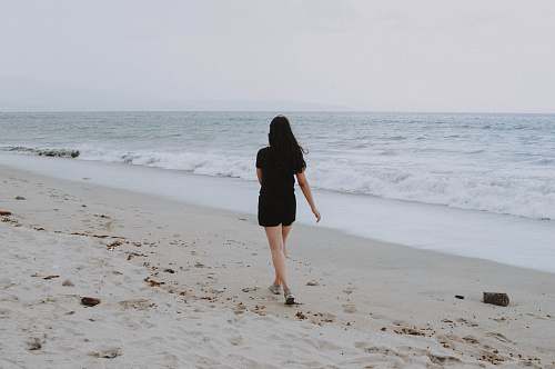 beach woman walking on beach shore coast