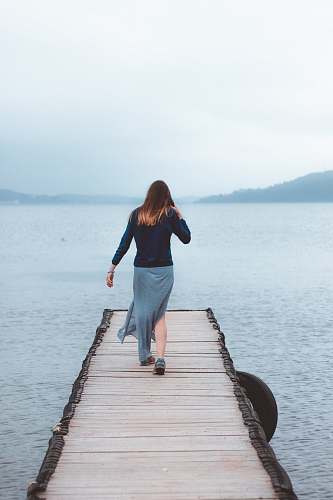 people woman walking on dock near water human