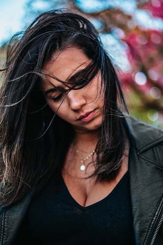 people woman wearing black leather jacket and black V-neck top human