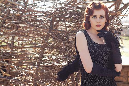 people woman wearing black sleeveless scoop-neck top and black gloves woman