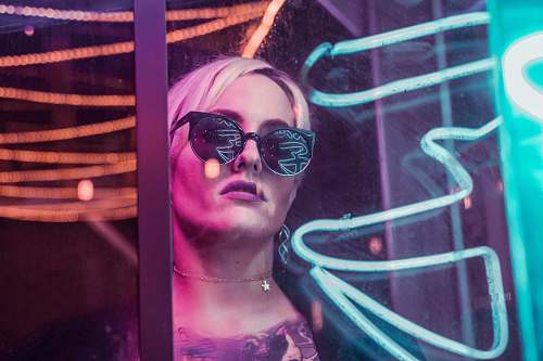 people woman wearing black sunglasses through glass human