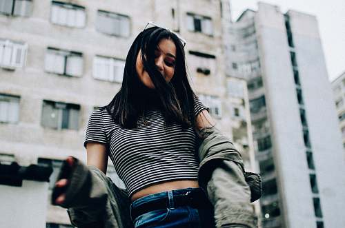 human woman wearing striped crop-top and jacket people