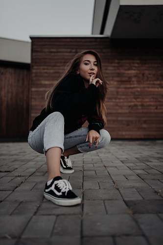 people women's black long-sleeved top and gray denim jeans human