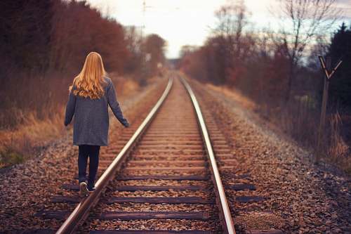 girl woman walking on rail road woman