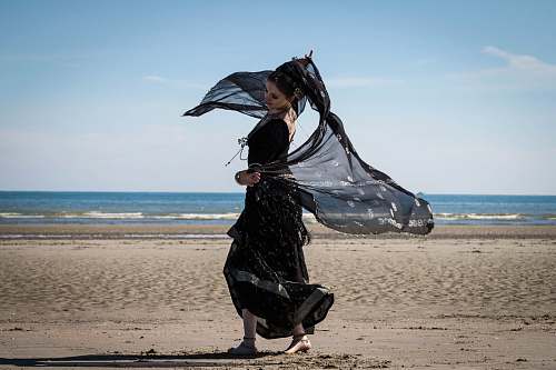 beach woman dancing on seashore water