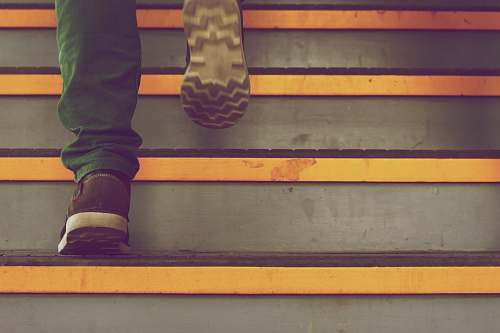 feet person wearing green pants steps