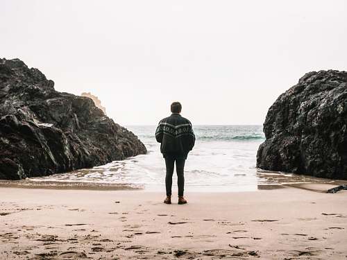 sea man near rock formation outdoors