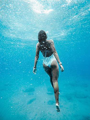 underwater woman swimming under water woman