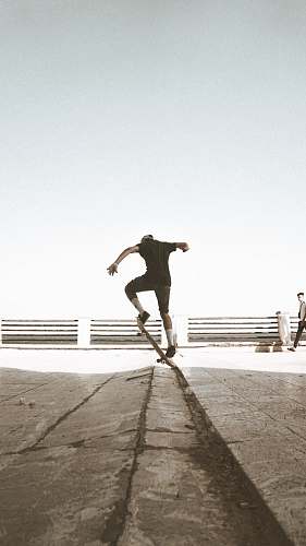 clothing close-up photography of person doing stunt on skateboard shorts
