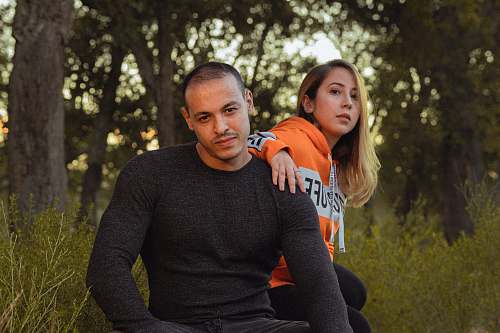 clothing man and woman sitting under trees sleeve