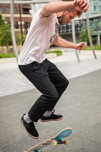 clothing man doing skateboard tricks footwear