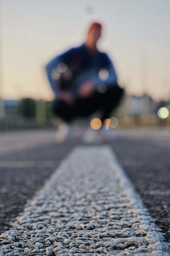 tarmac man kneeling on road road