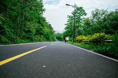tarmac person walking on street during daytime road