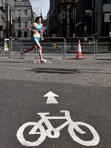 tarmac woman running on gray concrete pavement taken at daytime london