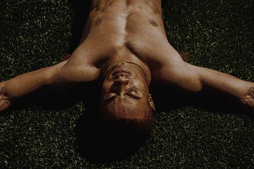 human man lying on grass field person