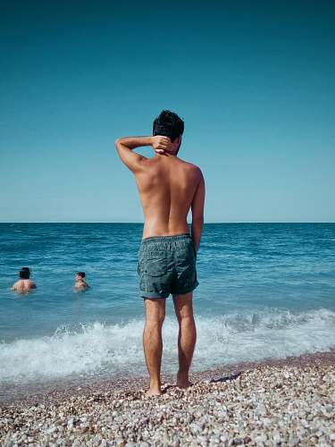 apparel man standing on shore clothing