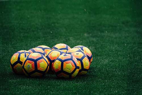 soccer pile of yellow-orange-and-red Nike soccer balls sport