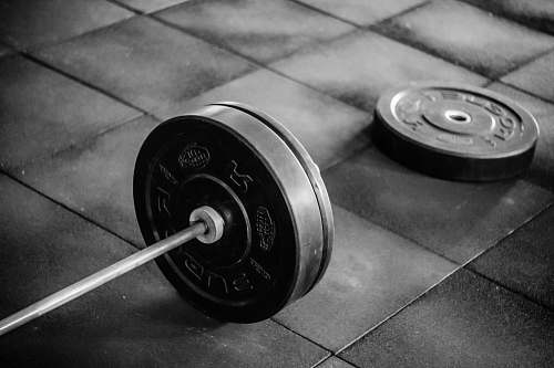 fitness black barbell on tile flooring gambaru crossfit
