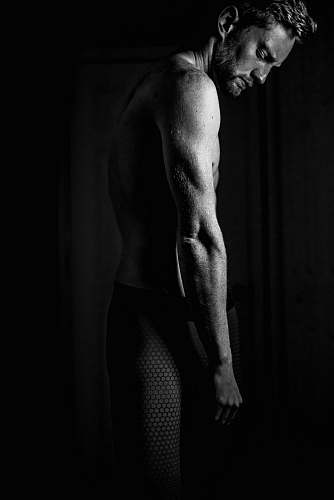human grayscale photography of man in black pants person
