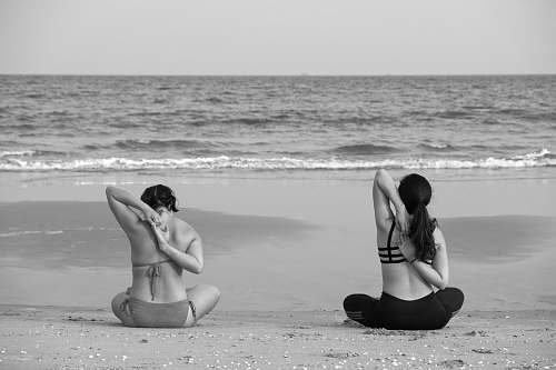 back grayscale photography unknown persons seating near body of water nature