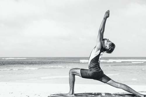 exercise man stretching on seashore yoga
