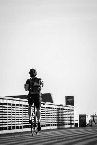 shorts person riding road bike in black and white photo apparel