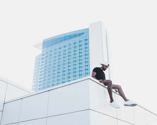 detroit man sitting at the roof of the building united states