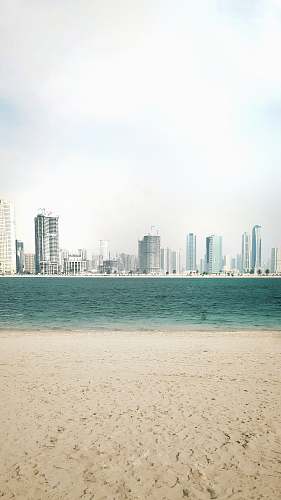 town body of water near cityscape at daytime urban