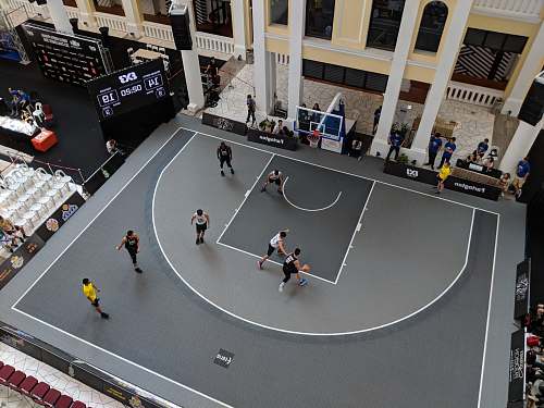grey man playing basketball on gray court basketball hoop