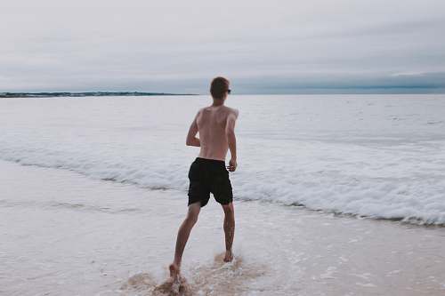 apparel man running on seashore shorts