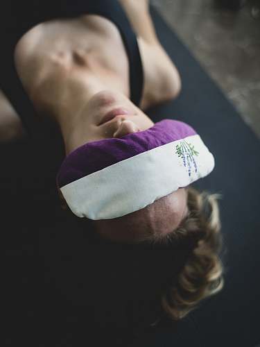 yoga woman put purple and white pad on her forehead apparel