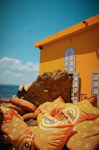 pillow orange pillows near rock formation furniture