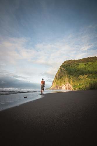 fitness man in beach jogging