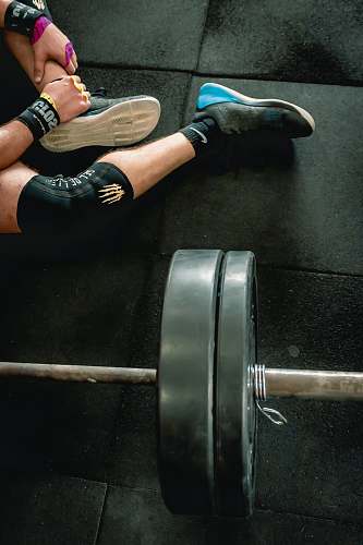 shoe person sitting beside barbell clothing